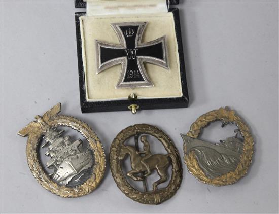 An iron cross and three badges